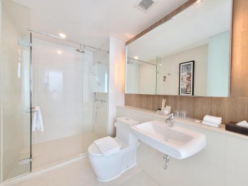 a bathroom with a toilet and a sink and a shower at On 8 Sukhumvit Nana Bangkok by Compass Hospitality in Bangkok