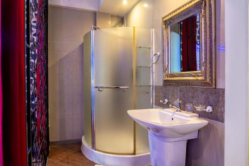 a bathroom with a sink and a shower at The White Rabbit Hostel in Ban Si Than