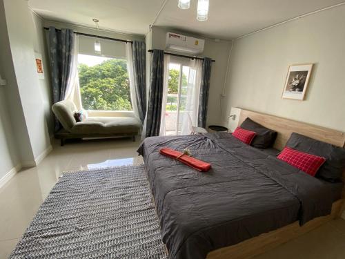 a bedroom with a large bed with a large window at Private room hosted by Boyce 415 in Chiang Mai