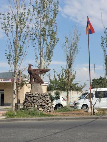 a statue on the side of a street with a flag at Morik 's & Tours in Yerevan