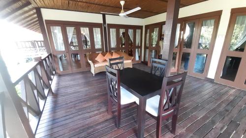 a screened in porch with a table and chairs at Nongsa Village in Nongsa