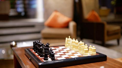 a chess board on a table in a living room at On 8 Sukhumvit Nana Bangkok by Compass Hospitality in Bangkok