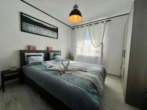 a bedroom with a large bed with a swan on it at Le Clos fleuri in Fauvillers