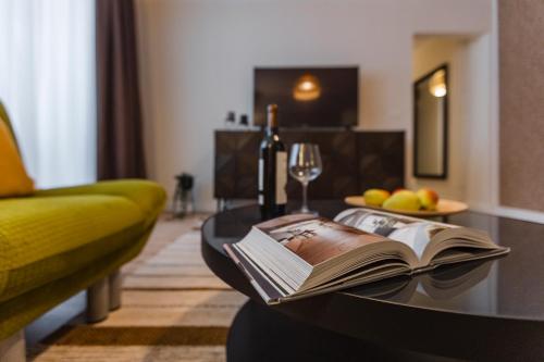 a book on a coffee table in a living room at Rox Central Apartments 4 in Timişoara