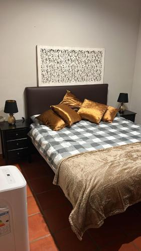 a bed with pillows on it in a bedroom at Villa Sol Luxury Costa Brava Golf in Peralada