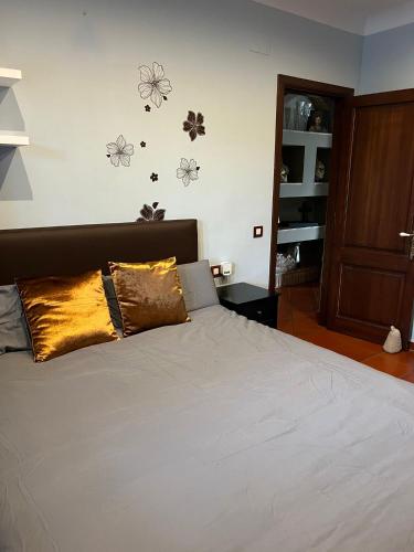 a bedroom with a bed with white sheets and pillows at Villa Sol Luxury Costa Brava Golf in Peralada
