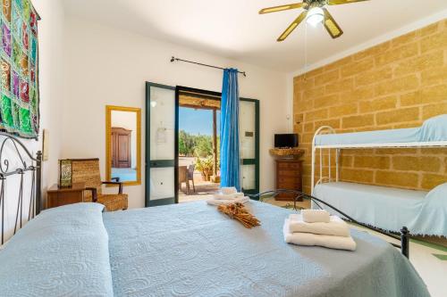 a bedroom with a bed with towels on it at Domus mea salento Arazzo Blu in Ugento