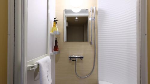 a bathroom with a shower and a mirror at Onyado Nono Matsue Natural Hot Spring in Matsue