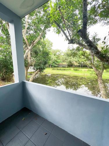 a window in a room with a view of a pond at Srikij GardenHome Resort in Sa Kaeo