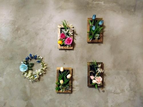 a group of flowers in wooden boxes on a wall at Cozy ground floor rooms at the heart of Jackson Heights in Queens