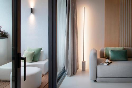 a bathroom with a couch and a chair in a room at Hotel Byron in Forte dei Marmi