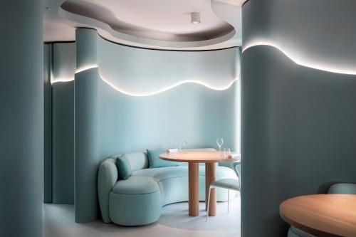 a dining room with a table and a blue wall at Hotel Byron in Forte dei Marmi