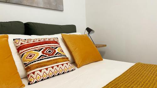 a bed with two pillows and a lamp on it at 169Home in Catania