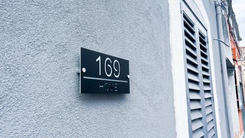 a sign on the side of a building at 169Home in Catania