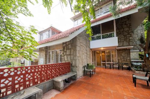 a building with benches in front of it at BYOC Hostels in Bangalore