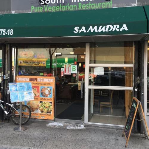 a sandwich shop with a sign in front of it at Cozy studio at the heart of Jackson Heights in Queens