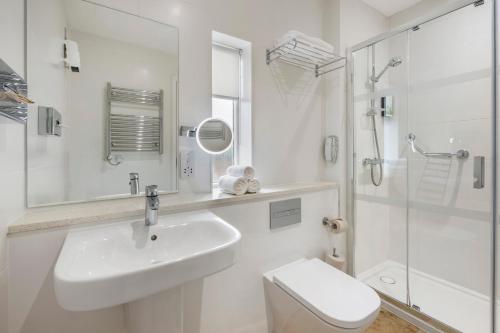 a bathroom with a sink and a toilet and a shower at Wychnor Park Country Club in Barton under Needwood
