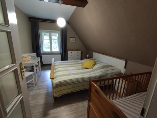 a bedroom with a bed with a yellow pillow on it at Haus am Fluß in Oberndorf