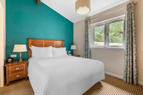 a bedroom with a large bed and a window at Wychnor Park Country Club in Barton under Needwood
