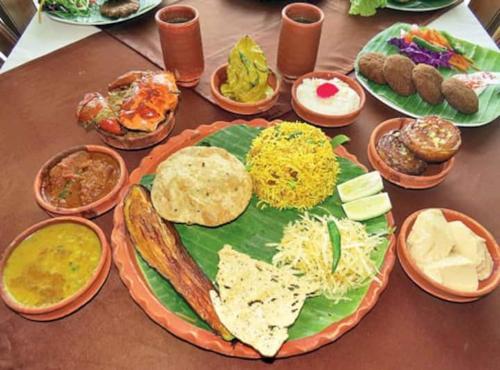 a table with plates of different types of food at Cozy studio at the heart of Jackson Heights in Queens