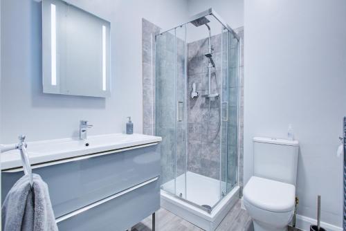 a bathroom with a shower and a toilet and a sink at Pass the Keys Stunning Sea Front Views in Westcliff-On-Sea