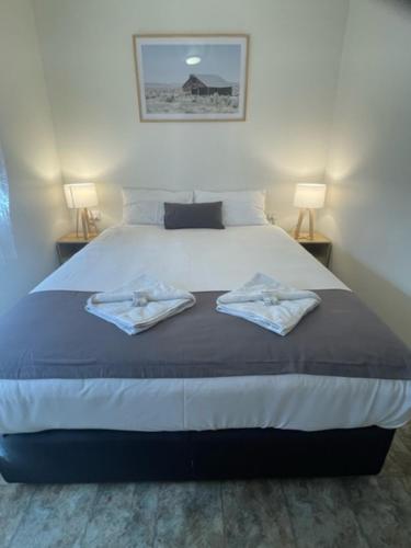 a bedroom with a bed with two towels on it at Penola Coonawarra Caravan Park in Penola