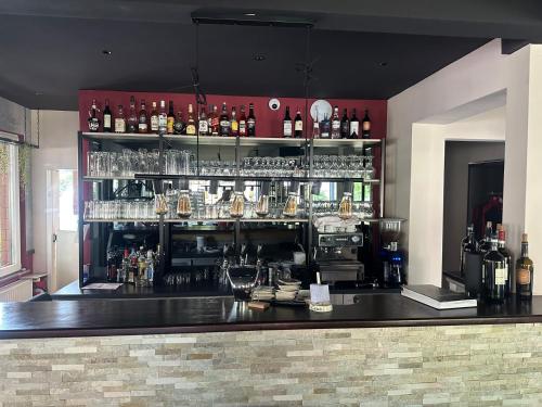 a bar with a lot of bottles and glasses at Hotel Da Toni in Neuenkirchen