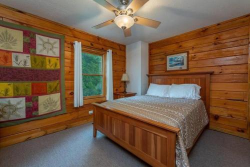 a bedroom with a bed and a ceiling fan at Gorgeous Mountain View Cabin on 12 Acres in Candler