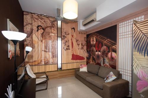 a living room with a couch and a large mural at Kisetsu no ie, KLCC Kuala Lumpur in Kuala Lumpur
