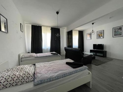 sypialnia z łóżkiem i krzesłem w obiekcie Ruhrpott Apartment Zentral Comfort w mieście Herne