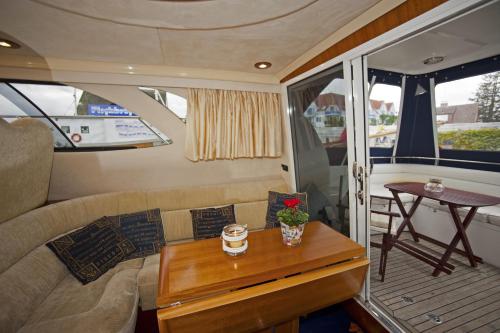 a living room with a couch and a table at Hotel Boddenhus Garni in Zingst