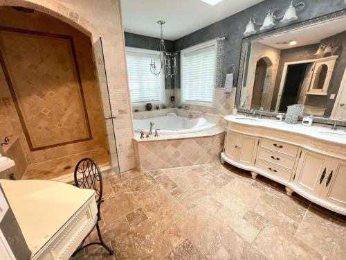 a large bathroom with a tub and a sink at Gorgeous Home w Pool & Hot Tub in Schenectady