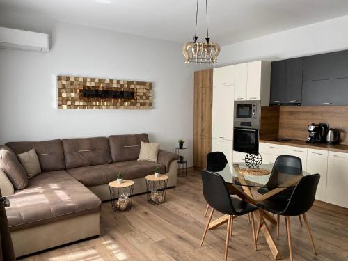 a living room with a couch and a table and chairs at La Luna - High-end 2BD Flat in the TOP centre by Flat Mаnager in Sofia