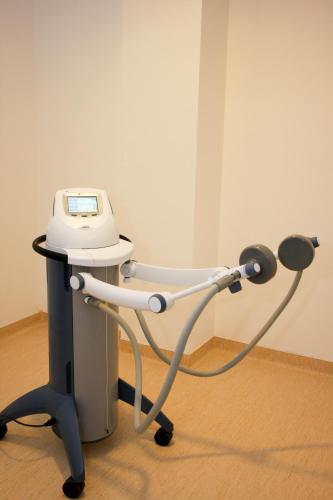 a hospital examination table with a machine on it at Hotel President in Baile Felix