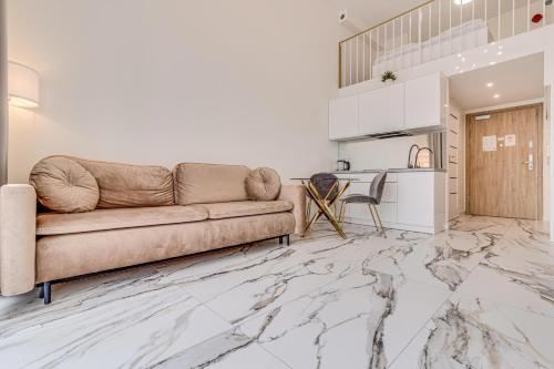 a living room with a couch and a table at RentPlanet - Apartamenty Zarembowicza in Wrocław