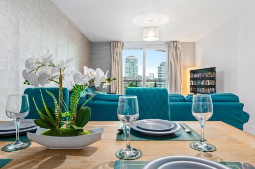 a dining room with a table with wine glasses at St, George Wharf Vauxhall Bridge large 2Bedrooms apartment with River View panoramic balcony in London