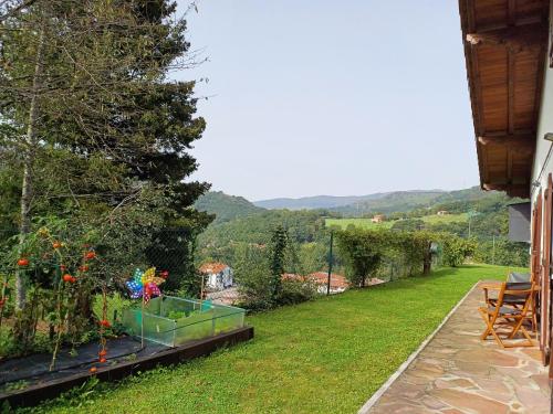 a garden with a view of a house at Casa Rural Amazonas in Sumbilla