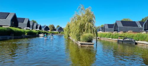a river with some people on swans in it at Lutz Watervilla's Balk in Balk