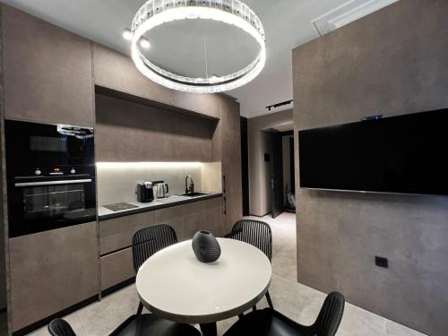 a kitchen with a table and chairs in a room at Apart leitmotif in Tbilisi City