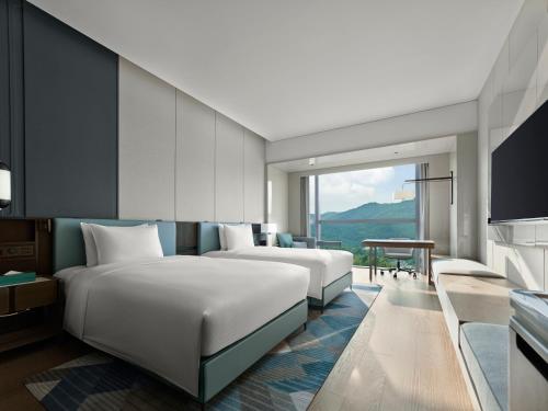 Postel nebo postele na pokoji v ubytování Hilton Zhuhai