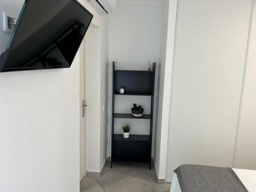 a bedroom with a black book shelf in a white wall at Old Town House in Loulé