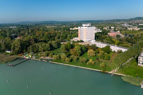 an aerial view of a building next to a river at Danubius Hotel Marina in Balatonfüred