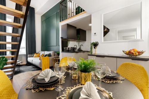 a dining room and kitchen with a table and chairs at Tempus Te Premium Duo Lofts Tartu - private cinema, gym and terrace in Tartu