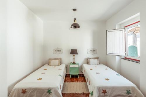 Ένα ή περισσότερα κρεβάτια σε δωμάτιο στο Pinheirinha Guest House