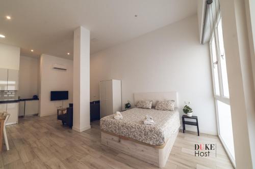 a large bedroom with a bed and a kitchen at Santa Maria de la cabeza Apartments in Madrid
