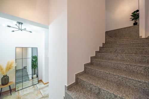 a staircase in a home with white walls and a stair case at Three Lilies Apartments in Plovdiv
