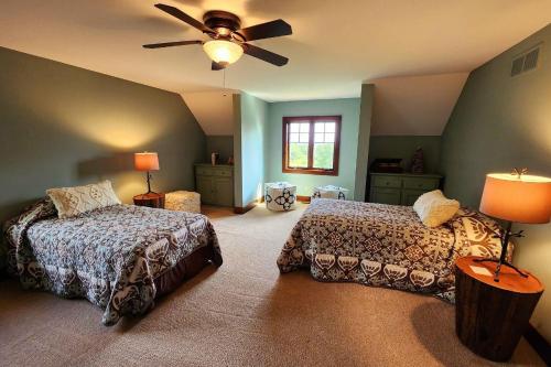 a bedroom with two beds and a ceiling fan at Reflections in Harbor Springs