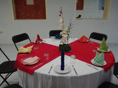 a table with a red and white table cloth at Hotel El Español Centro Historico in Mérida