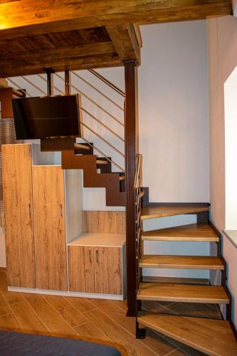 a staircase in a living room with wooden floors at L'Antica Fontana - Casa Vacanze B&B in Viggianello