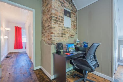 an office with a desk and a chair and a brick wall at Daydream by The Atlanta Beltline Trail in Cabbagetown in Atlanta